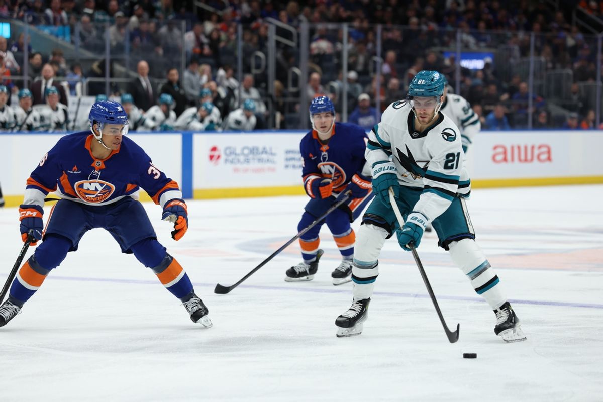 Jan 18, 2025; Elmont, New York, USA;  San Jose Sharks center Alexander Wennberg (21) skates up ice against the New York Islanders during the first period at UBS Arena. Mandatory Credit: Thomas Salus-Imagn Images