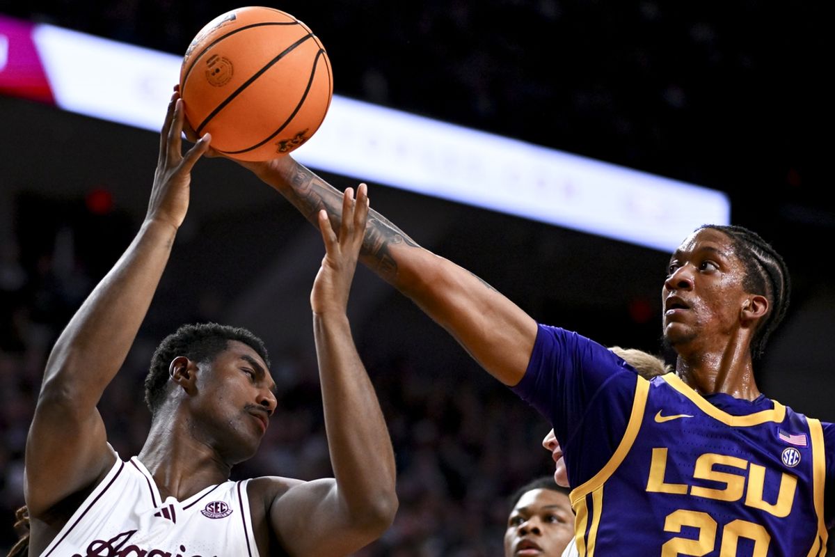 Jan 18, 2025; College Station, Texas, USA; LSU Tigers forward Derek Fountain (20) grabs the rebound against Texas A&M Aggies forward Henry Coleman III (15) during the first half  at Reed Arena. Mandatory Credit: Maria Lysaker-Imagn Images