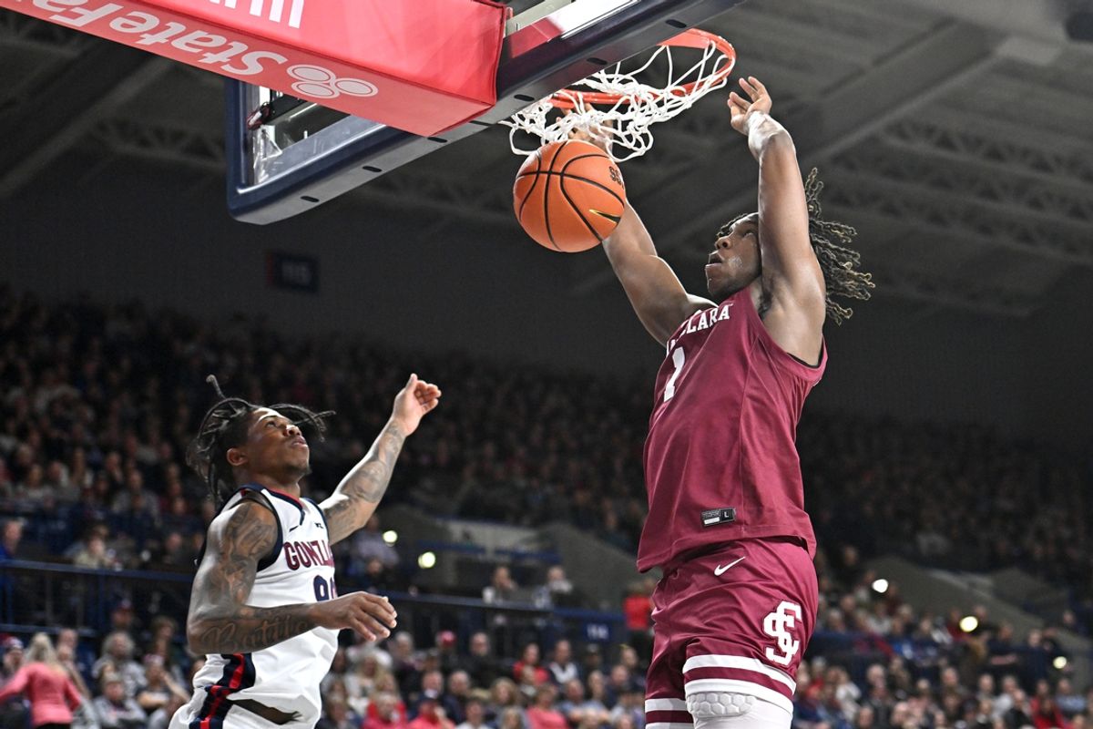 Jan 18, 2025; Spokane, Washington, USA; Santa Clara Broncos guard Tyeree Bryan (1) dunks the ball against Gonzaga Bulldogs guard Khalif Battle (99) in the first half at McCarthey Athletic Center. Mandatory Credit: James Snook-Imagn Images
