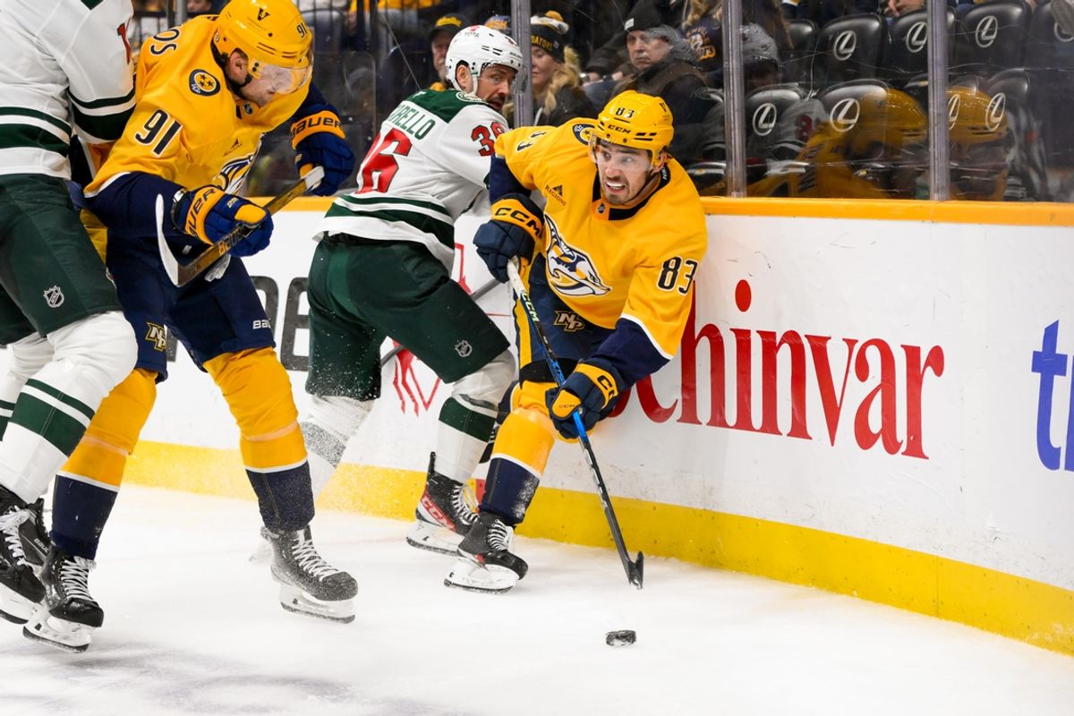 Jan 18, 2025; Nashville, Tennessee, USA;  Minnesota Wild right wing Mats Zuccarello (36) and Nashville Predators defenseman Adam Wilsby (83) battle for the puck during the second period at Bridgestone Arena. Mandatory Credit: Steve Roberts-Imagn Images
