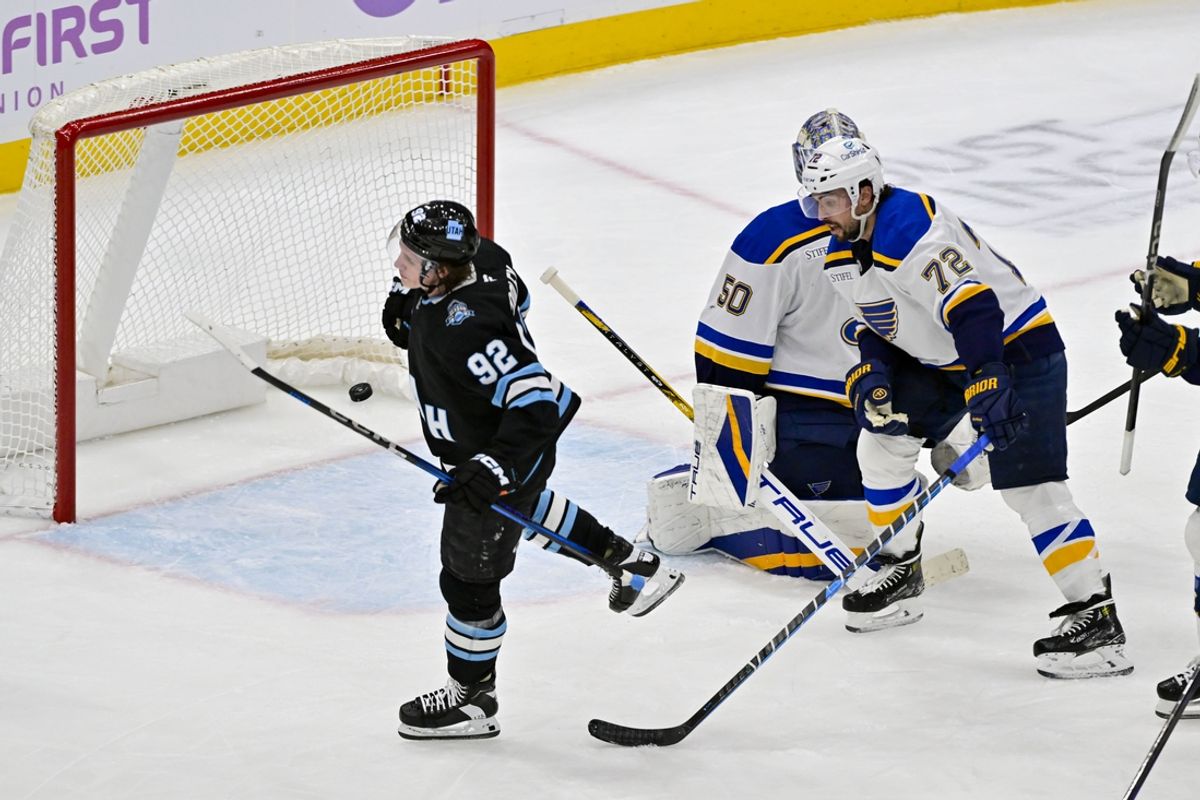 Jan 18, 2025; Salt Lake City, Utah, USA; Utah Hockey Club center Logan Cooley (92) reacts after scoring past St. Louis Blues goalie Jordan Binnington (50) during second period at the Delta Center. Mandatory Credit: Christopher Creveling-Imagn Images