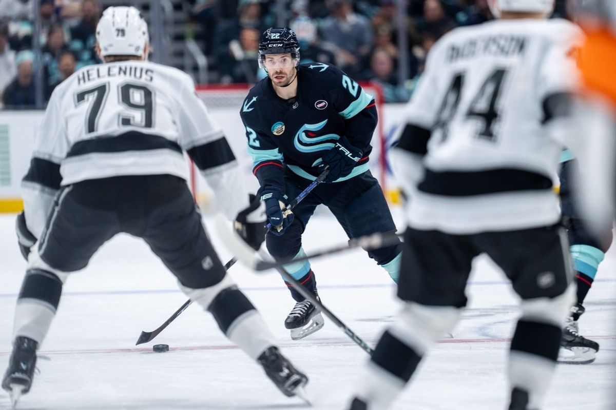 Jan 18, 2025; Seattle, Washington, USA;  Seattle Kraken forward Oliver Bjorkstrand (22) skates with the puck during the second period against the Los Angeles Kings at Climate Pledge Arena. Mandatory Credit: Stephen Brashear-Imagn Images