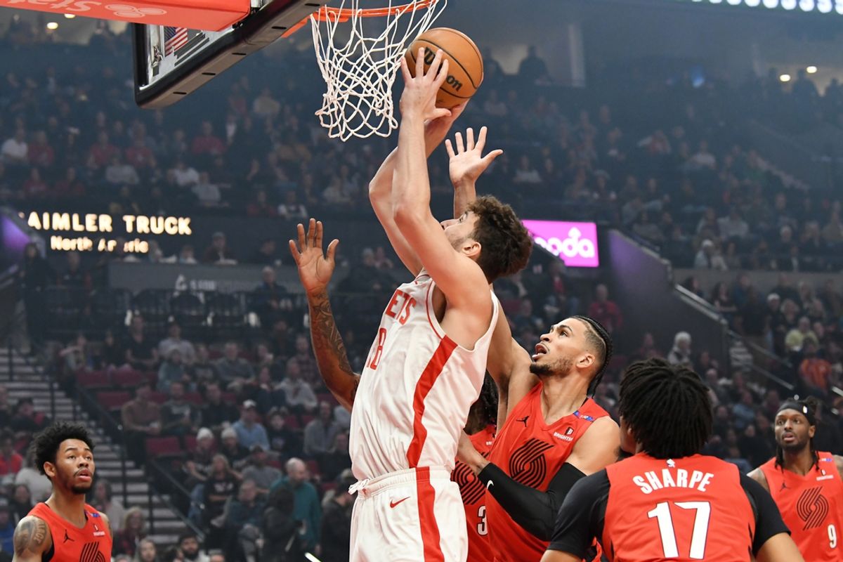 Jan 18, 2025; Portland, Oregon, USA;  Houston Rockets center Alperen Sengun (28) drives to the hoop against Portland Trail Blazers forward Toumani Camara (33) during the first half at Moda Center. Mandatory Credit: Brian Murphy-Imagn Images