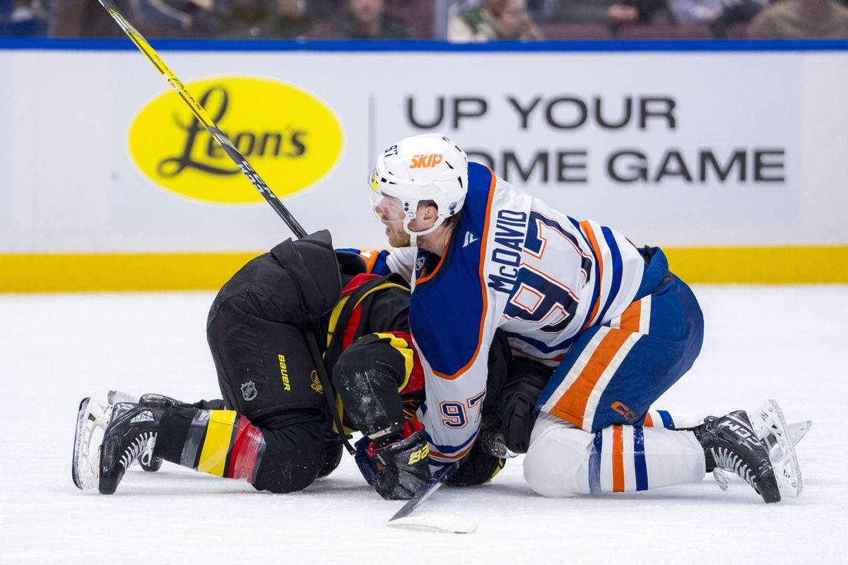 Jan 18, 2025; Vancouver, British Columbia, CAN; Edmonton Oilers forward Connor McDavid (97) battles with Vancouver Canucks forward Conor Garland (8) in the third period at Rogers Arena. Mandatory Credit: Bob Frid-Imagn Images