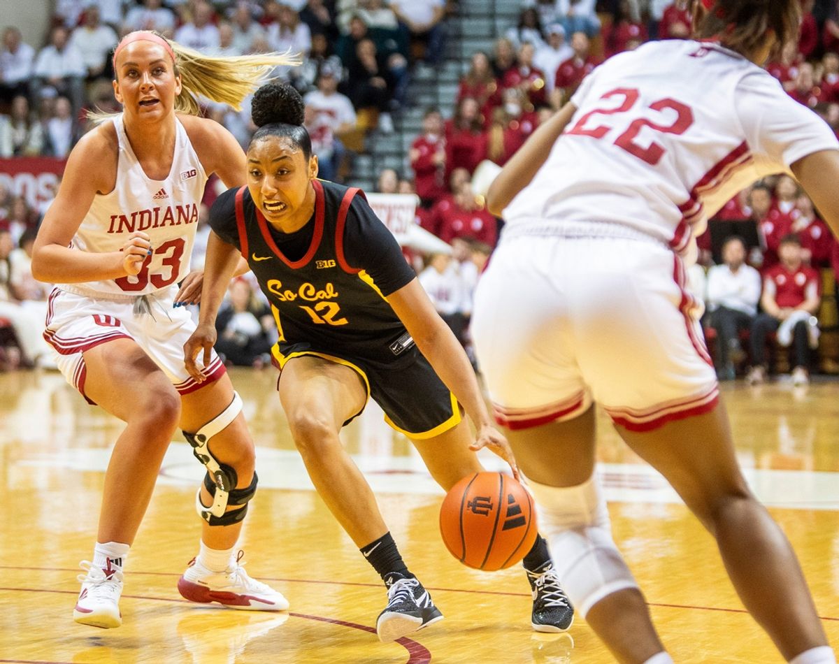 USC's JuJu Watkins (12) drives past Indiana's Sydney Parrish (33) during the Indiana versus University of Southern California women's basektball game at Simon Skjodt Assembly Hall on Sunday, Jan. 19, 2025.