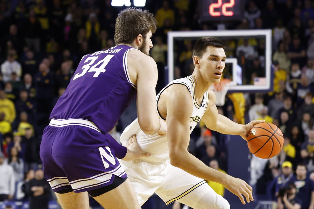 Jan 19, 2025; Ann Arbor, Michigan, USA;  Michigan Wolverines center Vladislav Goldin (50) dribbles against Northwestern Wildcats center Matthew Nicholson (34) in the first half at Crisler Center. Mandatory Credit: Rick Osentoski-Imagn Images