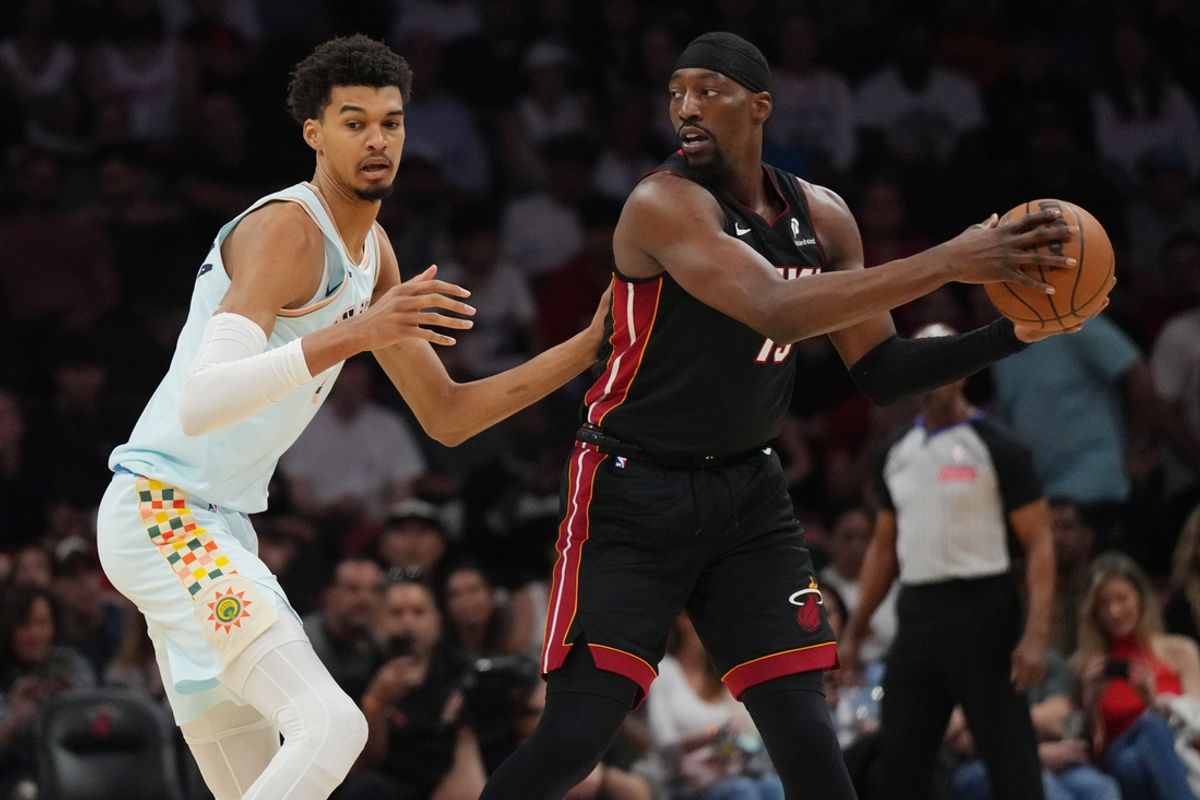 Jan 19, 2025; Miami, Florida, USA;  Miami Heat center Bam Adebayo (13) looks to pass the ball as San Antonio Spurs center Victor Wembanyama (1) defends during the first half at Kaseya Center. Mandatory Credit: Jim Rassol-Imagn Images