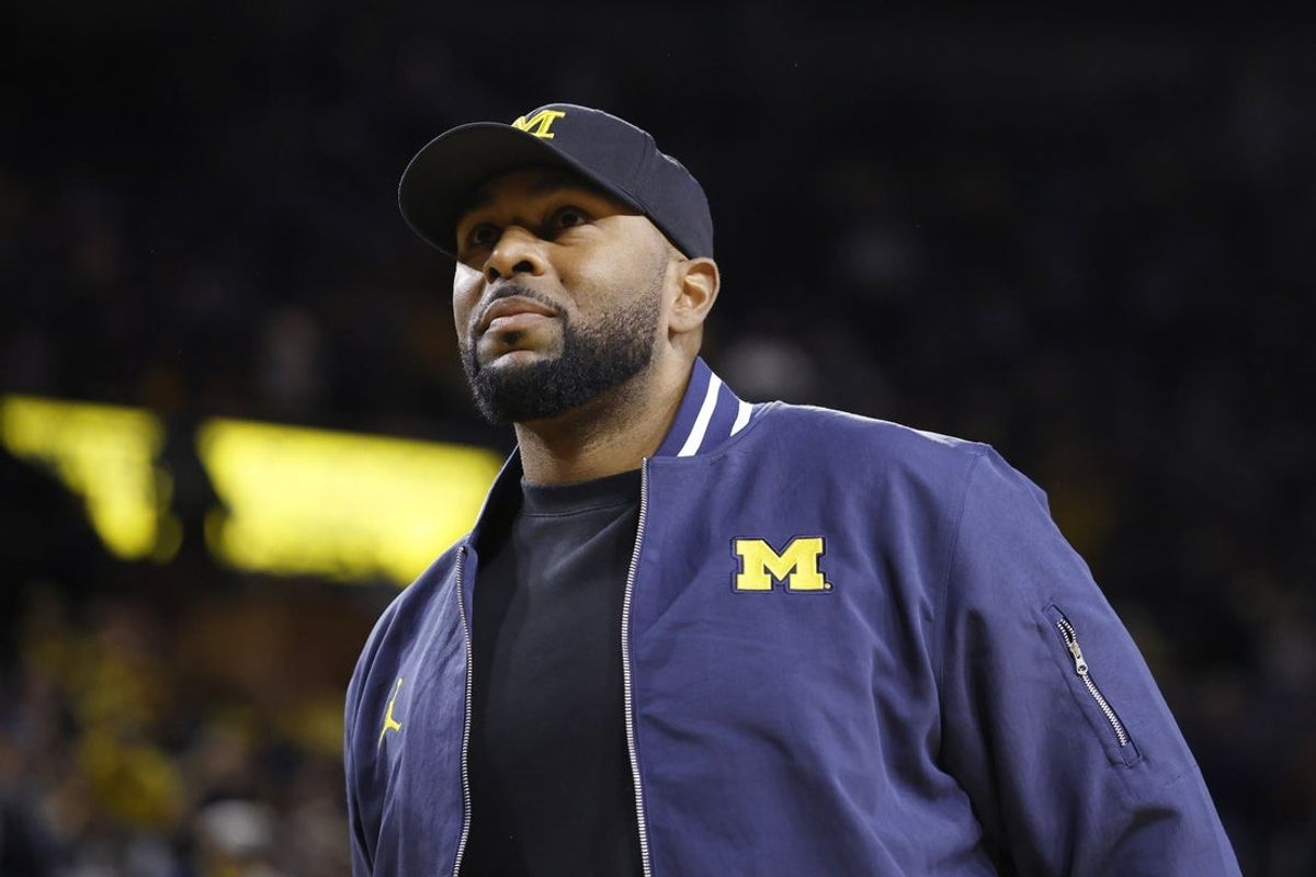 Jan 19, 2025; Ann Arbor, Michigan, USA;  Michigan Wolverines head football coach Sherrone Moore fires up the crowd in overtime of the basketball game against the Northwestern Wildcats at Crisler Center. Mandatory Credit: Rick Osentoski-Imagn Images