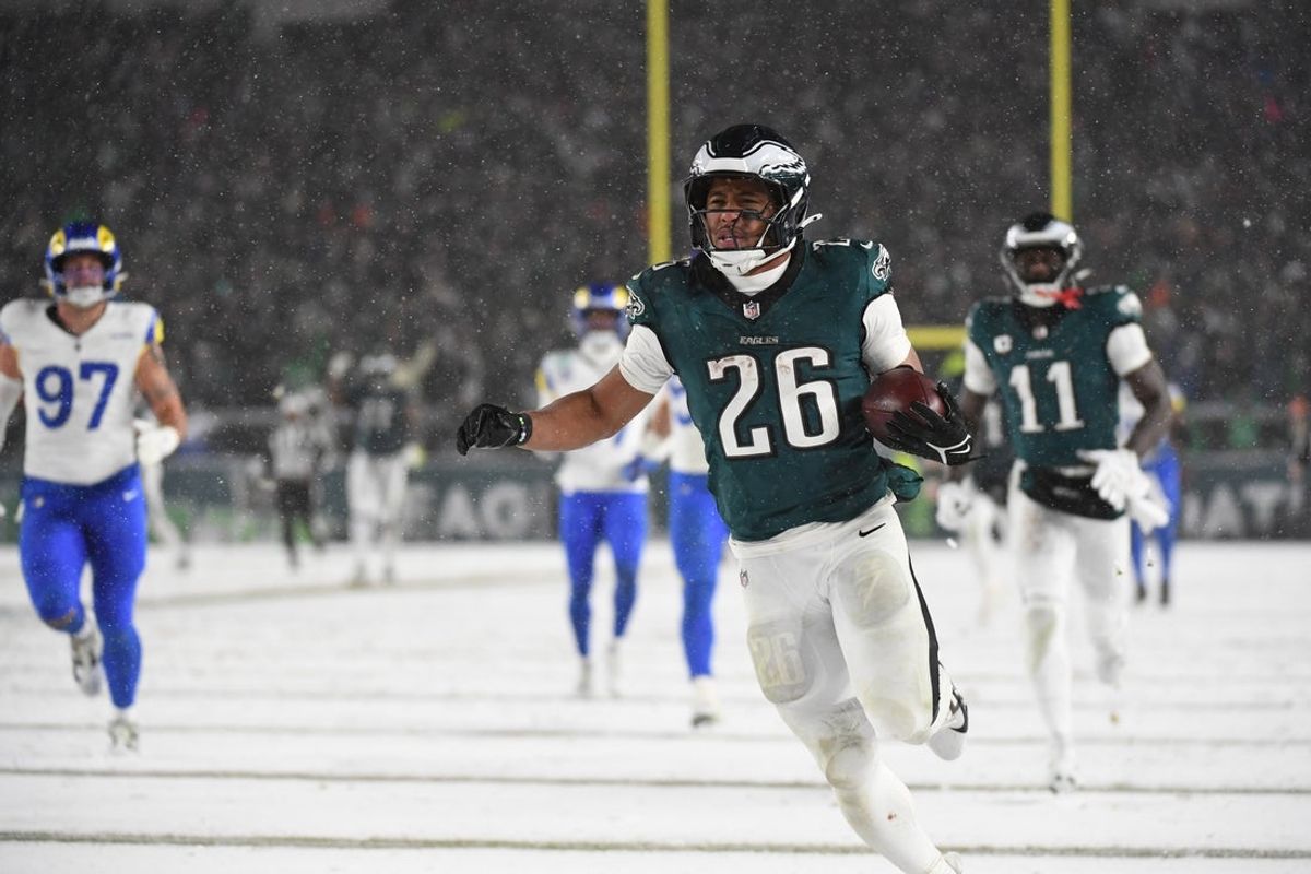 Jan 19, 2025; Philadelphia, Pennsylvania, USA; Philadelphia Eagles running back Saquon Barkley (26) carries the ball to score a touchdown against the Los Angeles Rams in the second half in a 2025 NFC divisional round game at Lincoln Financial Field. Mandatory Credit: Eric Hartline-Imagn Images