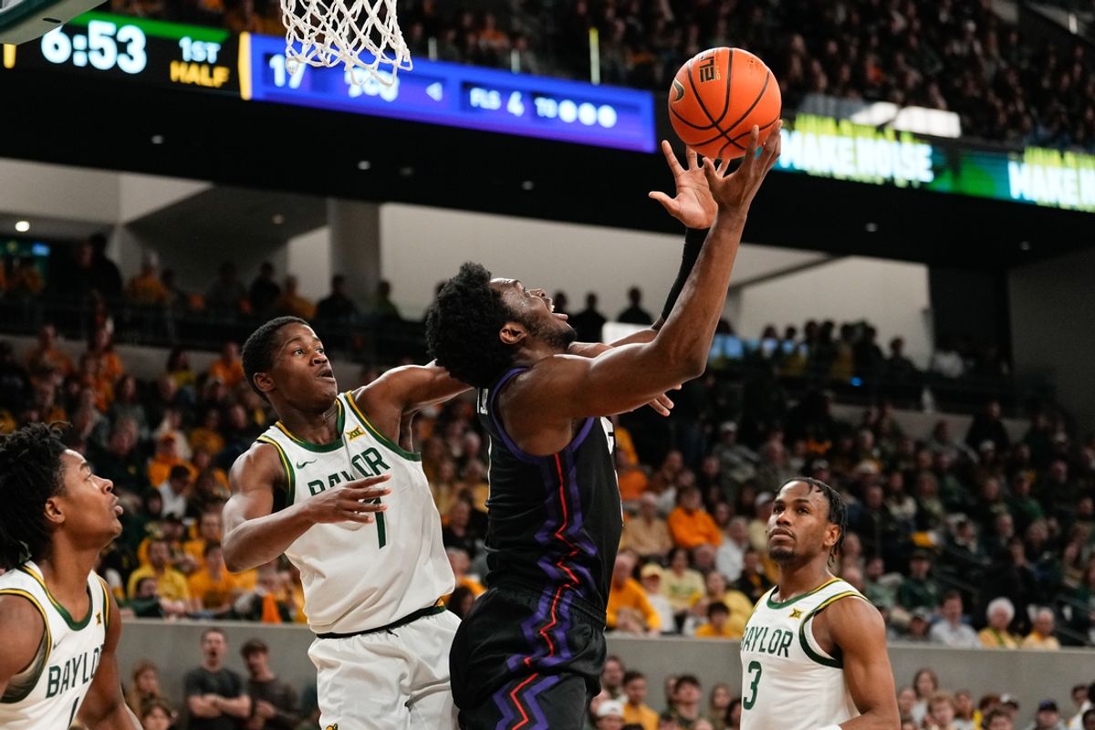 Jan 19, 2025; Waco, Texas, USA;  Baylor Bears guard VJ Edgecombe (7) fouls TCU Horned Frogs center Ernest Udeh Jr. (8) during the first half at Paul and Alejandra Foster Pavilion. Mandatory Credit: Chris Jones-Imagn Images