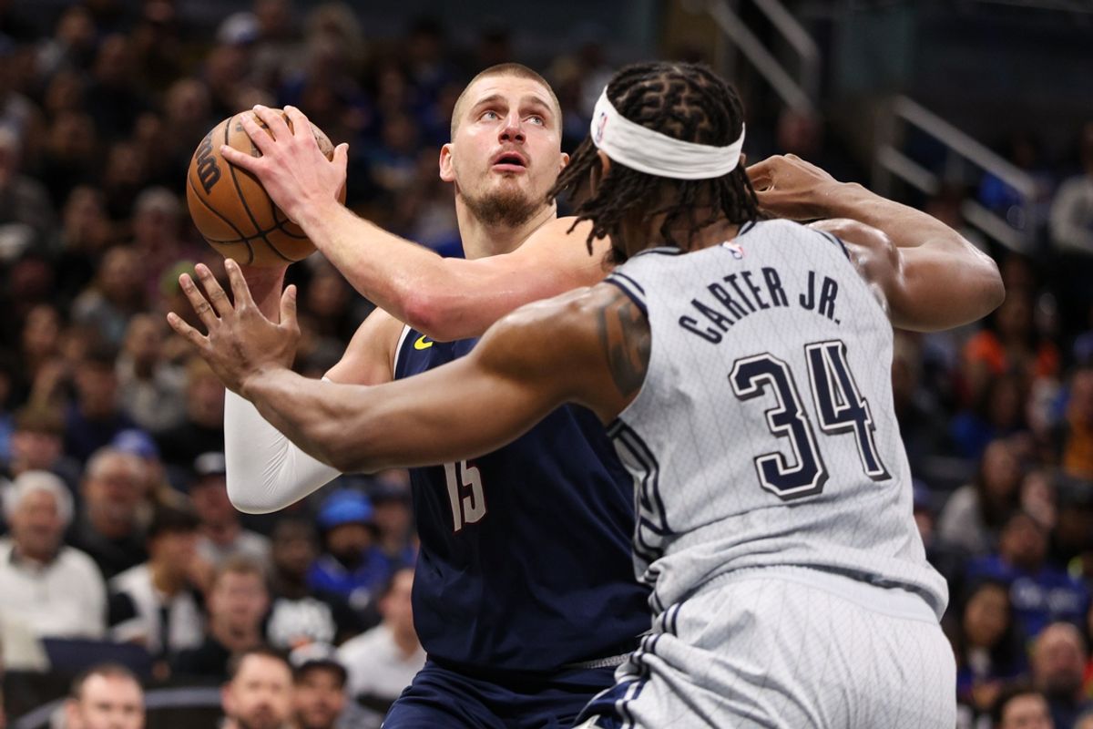 Jan 19, 2025; Orlando, Florida, USA; Denver Nuggets center Nikola Jokic (15) is guarded by Orlando Magic center Wendell Carter Jr. (34) in the first quarter at Kia Center. Mandatory Credit: Nathan Ray Seebeck-Imagn Images