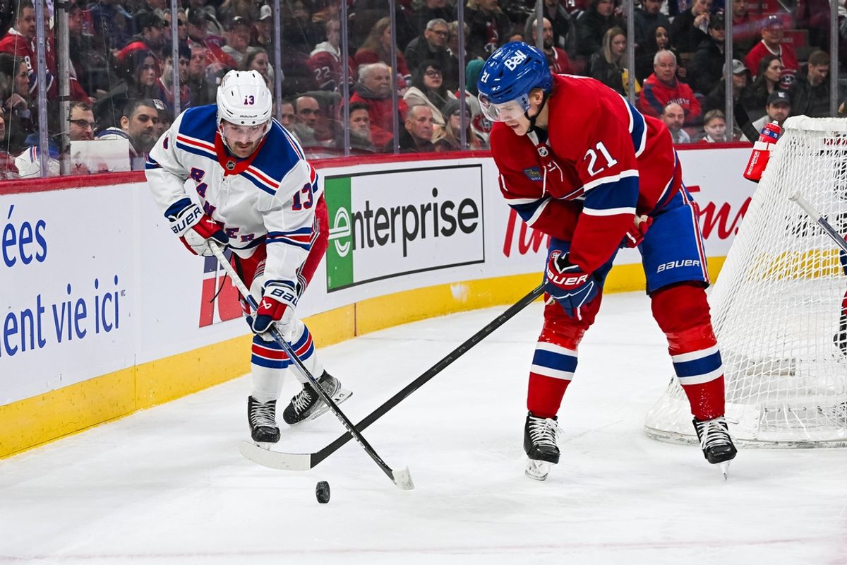 Jan 19, 2025; Montreal, Quebec, CAN; New York Rangers left wing Alexis Lafreniere (13) plays the puck against Montreal Canadiens defenseman Kaiden Guhle (21) during the first period at Bell Centre. Mandatory Credit: David Kirouac-Imagn Images
