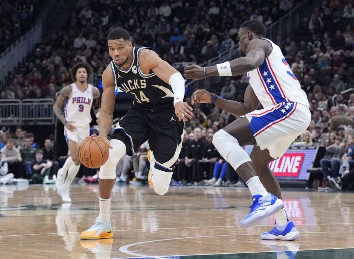 Jan 19, 2025; Milwaukee, Wisconsin, USA; Milwaukee Bucks forward Giannis Antetokounmpo (34) drives to the basket against Philadelphia 76ers center Adem Bona (30) in the first half at Fiserv Forum. Mandatory Credit: Michael McLoone-Imagn Images