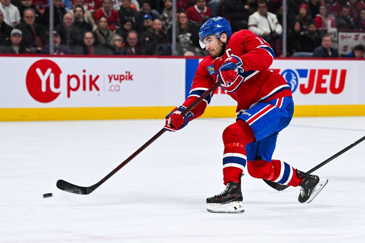 Jan 19, 2025; Montreal, Quebec, CAN; Montreal Canadiens center Nick Suzuki (14) shoots the puck against the New York Rangers during the second period at Bell Centre. Mandatory Credit: David Kirouac-Imagn Images