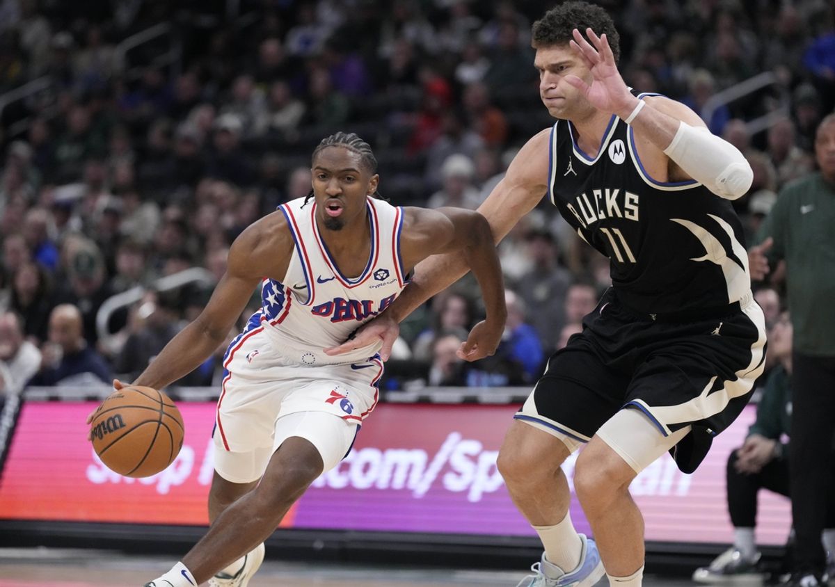 Jan 19, 2025; Milwaukee, Wisconsin, USA; Philadelphia 76ers guard Tyrese Maxey (0) drives to the basket against Milwaukee Bucks center Brook Lopez (11) int he second half at Fiserv Forum. Mandatory Credit: Michael McLoone-Imagn Images