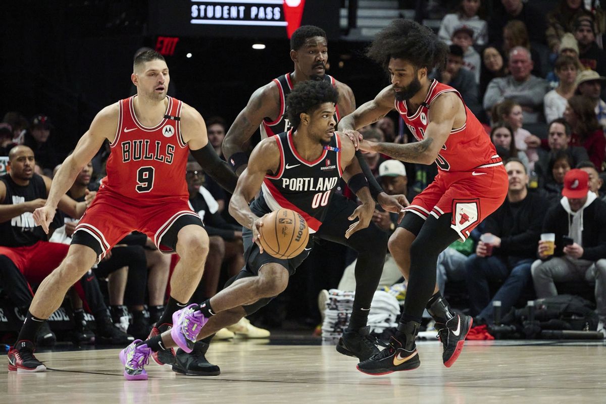 Jan 19, 2025; Portland, Oregon, USA; Portland Trail Blazers guard Scoot Henderson (00) drives to the basket during the first half against Chicago Bulls guard Coby White (0) at Moda Center. Mandatory Credit: Troy Wayrynen-Imagn Images