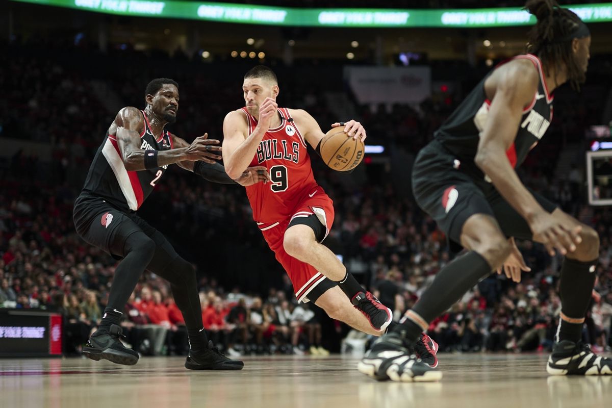 Jan 19, 2025; Portland, Oregon, USA; Chicago Bulls center Nikola Vucevic (9) drives to the basket during the first half against Portland Trail Blazers center Deandre Ayton (2) at Moda Center. Mandatory Credit: Troy Wayrynen-Imagn Images