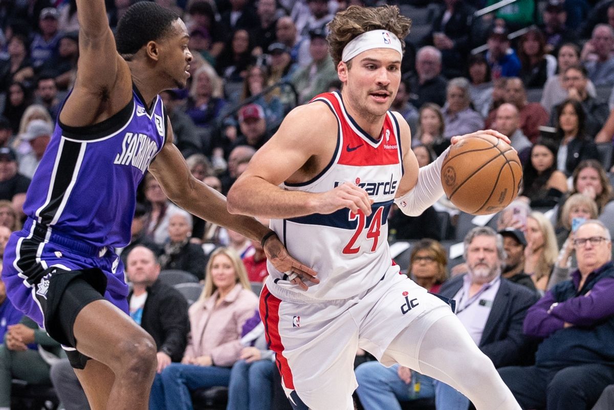 Jan 19, 2025; Sacramento, California, USA; Washington Wizards forward Corey Kispert (24) drives to the basket against Sacramento Kings guard De'Aaron Fox (5) during the first quarter at Golden 1 Center. Mandatory Credit: Ed Szczepanski-Imagn Images