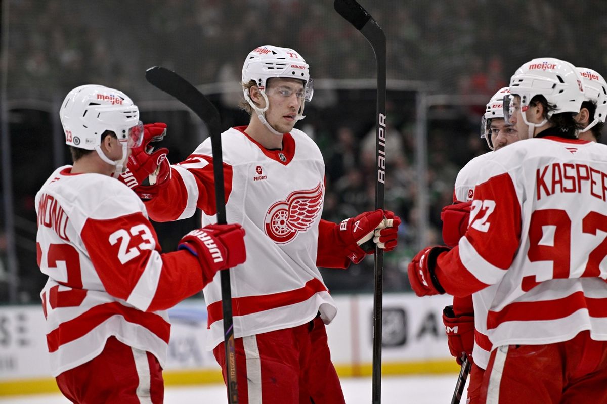Jan 19, 2025; Dallas, Texas, USA; Detroit Red Wings defenseman Simon Edvinsson (77) and center Marco Kasper (92) and left wing Lucas Raymond (23) celebrates a goal scored by Edvinsson against the Dallas Stars during the third period at the American Airlines Center. Mandatory Credit: Jerome Miron-Imagn Images