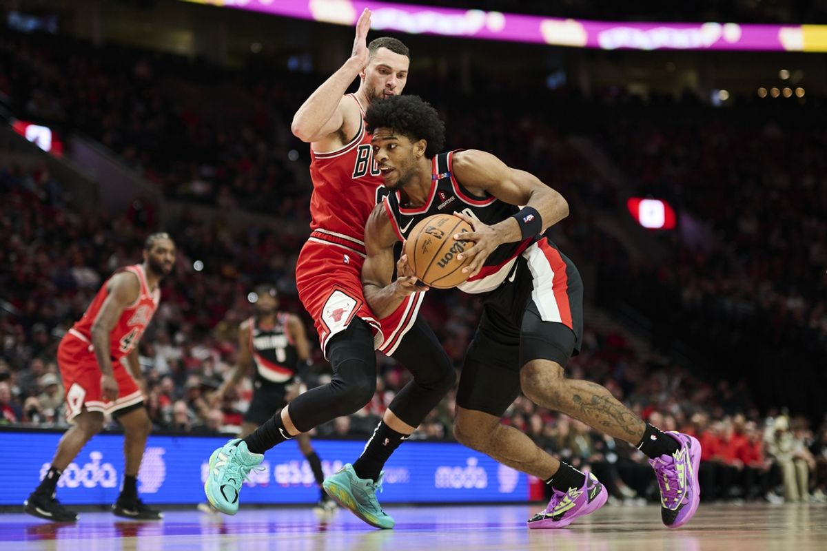 Jan 19, 2025; Portland, Oregon, USA; Portland Trail Blazers guard Scoot Henderson (00) drives to the basket during the second half against Chicago Bulls guard Zach LaVine (8) at Moda Center. Mandatory Credit: Troy Wayrynen-Imagn Images