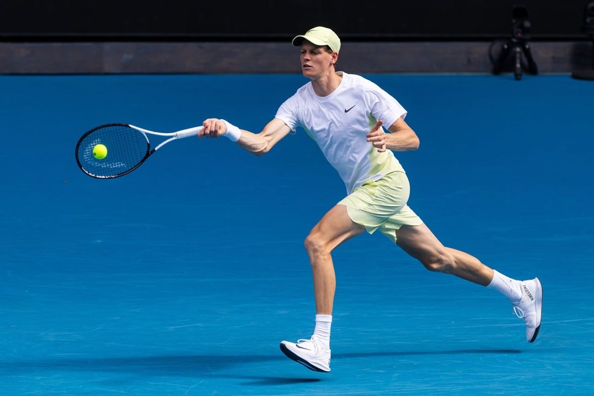 Jan 20, 2025; Melbourne, Victoria, Australia; Jannik Sinner of Italy hits a forehand during his match against Holger Rune of Denmark in the fourth round of the men's singles at the 2025 Australian Open at Melbourne Park. Mandatory Credit: Mike Frey-Imagn Images