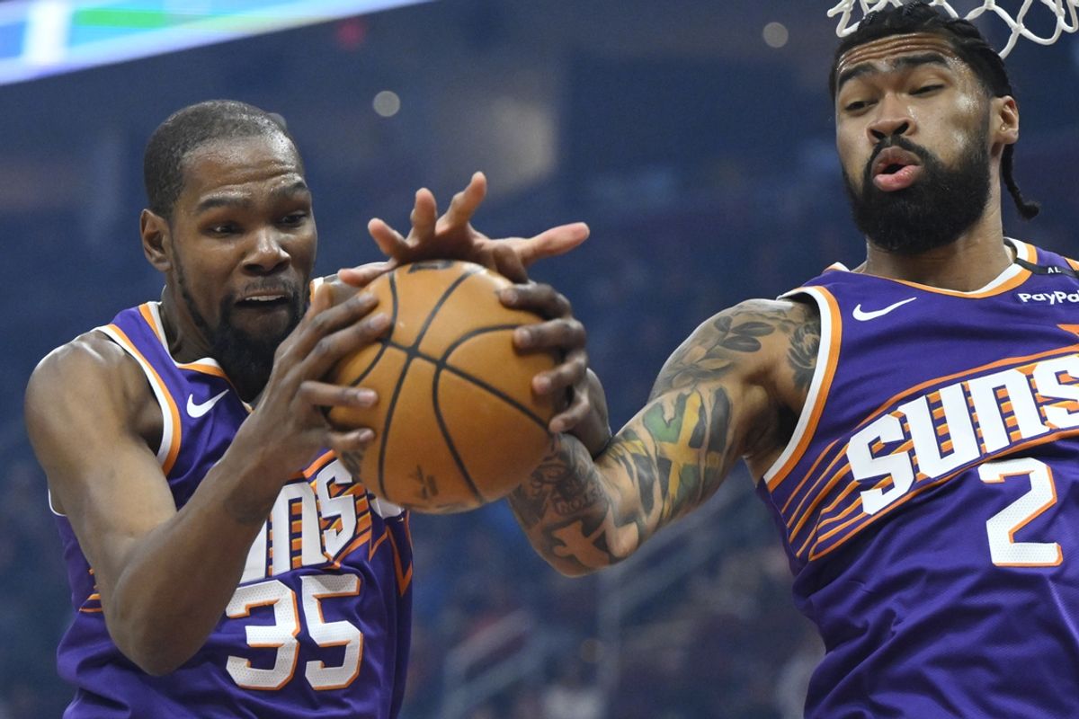 Jan 20, 2025; Cleveland, Ohio, USA; Phoenix Suns forward Kevin Durant (35) rebounds beside center Nick Richards (2) in the first quarter against the Cleveland Cavaliers at Rocket Mortgage FieldHouse. Mandatory Credit: David Richard-Imagn Images