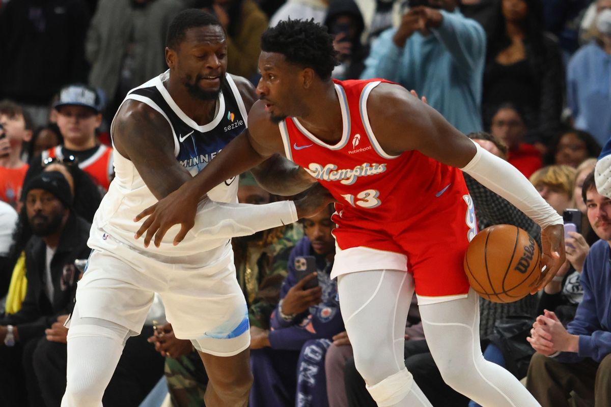 Jan 20, 2025; Memphis, Tennessee, USA; Memphis Grizzlies forward Jaren Jackson Jr. (13) dribbles as Minnesota Timberwolves forward Julius Randle (30) defends during the fourth quarter at FedExForum. Mandatory Credit: Petre Thomas-Imagn Images