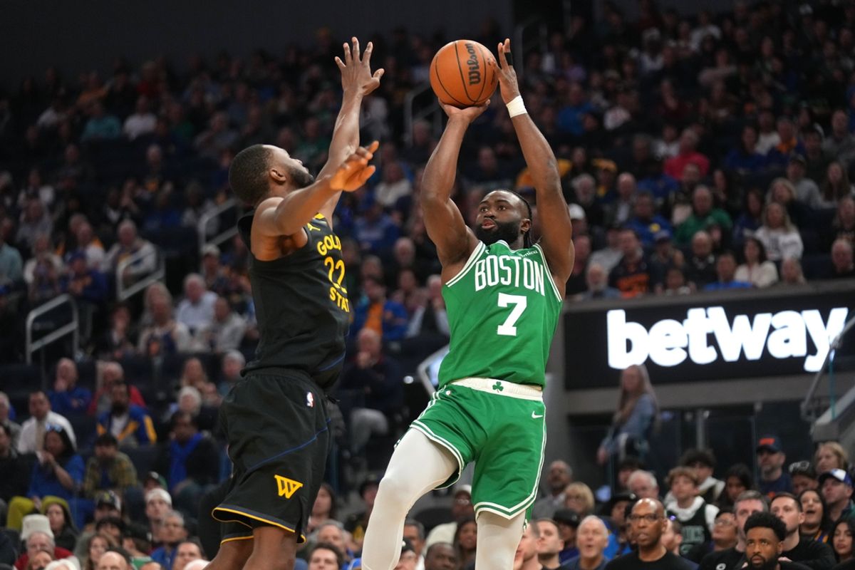 Jan 20, 2025; San Francisco, California, USA; Boston Celtics forward Jaylen Brown (7) shoots over Golden State Warriors forward Andrew Wiggins (22) in the second quarter at the Chase Center. Mandatory Credit: Cary Edmondson-Imagn Images