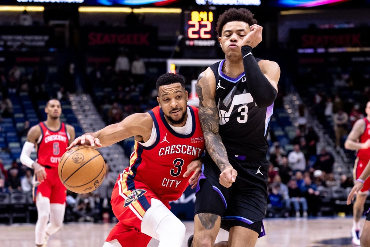 Jan 20, 2025; New Orleans, Louisiana, USA;  New Orleans Pelicans guard CJ McCollum (3) dribbles against Utah Jazz guard Keyonte George (3) during the first half at Smoothie King Center. Mandatory Credit: Stephen Lew-Imagn Images
