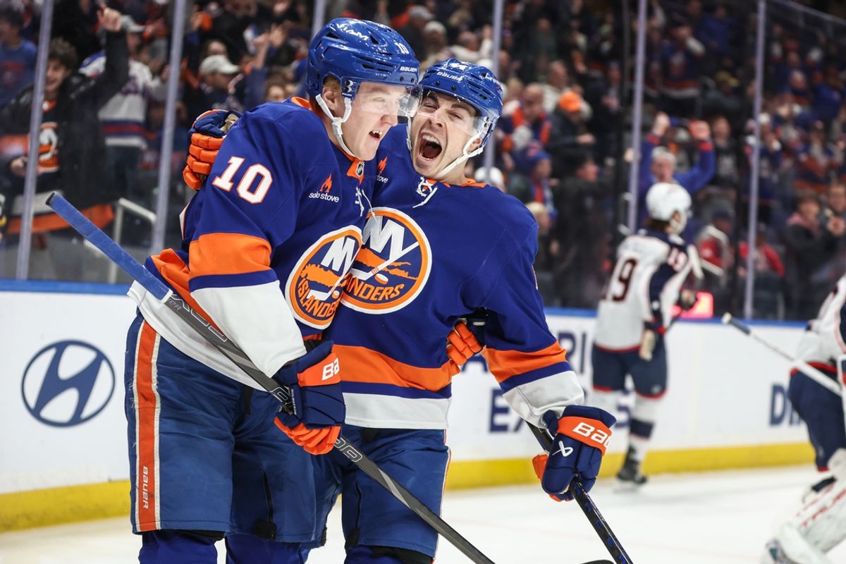 Jan 20, 2025; Elmont, New York, USA;  New York Islanders right wing Simon Holmstrom (10) is greeted by center Jean-Gabriel Pageau (44) after scoring a goal in the second period against the Columbus Blue Jackets at UBS Arena. Mandatory Credit: Wendell Cruz-Imagn Images