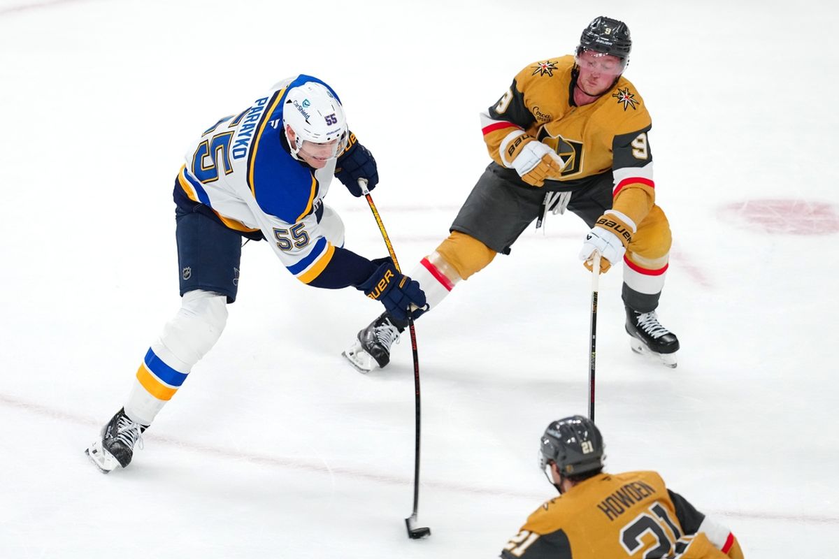 Jan 20, 2025; Las Vegas, Nevada, USA; St. Louis Blues defenseman Colton Parayko (55) shoots in front of Vegas Golden Knights center Jack Eichel (9) during an overtime period at T-Mobile Arena. Mandatory Credit: Stephen R. Sylvanie-Imagn Images