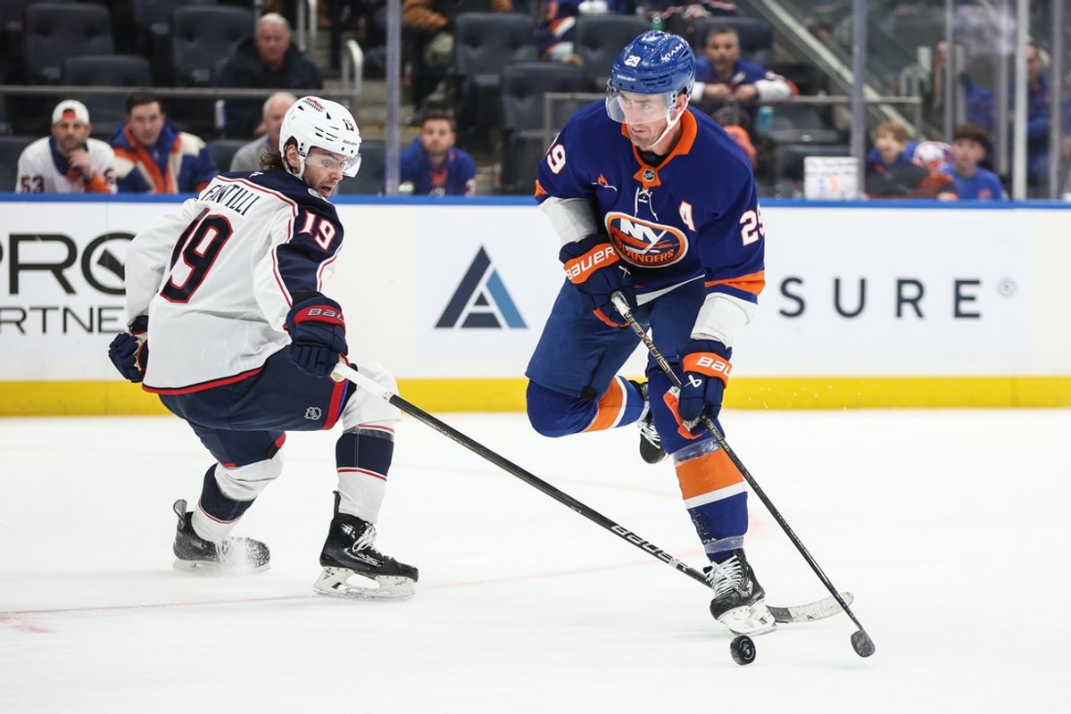 Jan 20, 2025; Elmont, New York, USA;  Columbus Blue Jackets center Adam Fantilli (19) and New York Islanders center Brock Nelson (29) chase after the puck in the second period at UBS Arena. Mandatory Credit: Wendell Cruz-Imagn Images