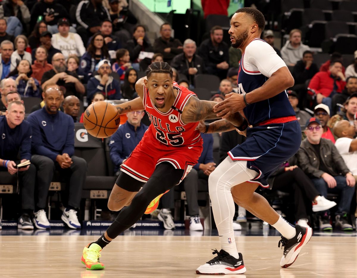 Jan 20, 2025; Inglewood, California, USA; Chicago Bulls forward Dalen Terry (25) drives against LA Clippers guard Norman Powell (24) during the 1st quarter at Intuit Dome. Mandatory Credit: Jason Parkhurst-Imagn Images