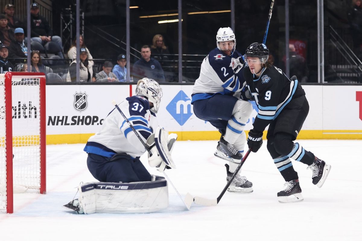 Jan 20, 2025; Salt Lake City, Utah, USA; Utah Hockey Club center Nick Schmaltz (8) scores a goal against Winnipeg Jets goaltender Connor Hellebuyck (37) and defenseman Dylan DeMelo (2) during the second period at Delta Center. Mandatory Credit: Rob Gray-Imagn Images