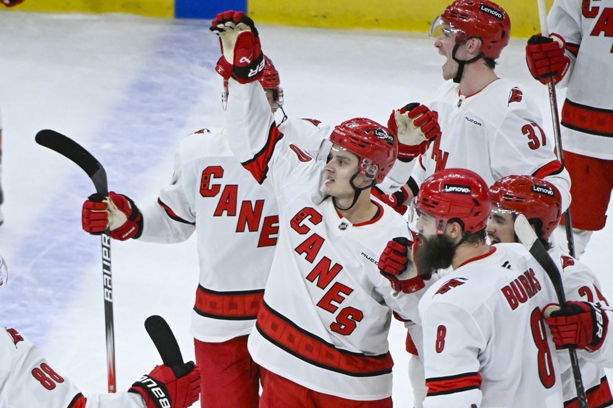 Jan 20, 2025; Chicago, Illinois, USA;  Carolina Hurricanes center Sebastian Aho (20) celebrates with teammates after he scores the game winning goal during the overtime period against the Chicago Blackhawks at the United Center. Mandatory Credit: Matt Marton-Imagn Images
