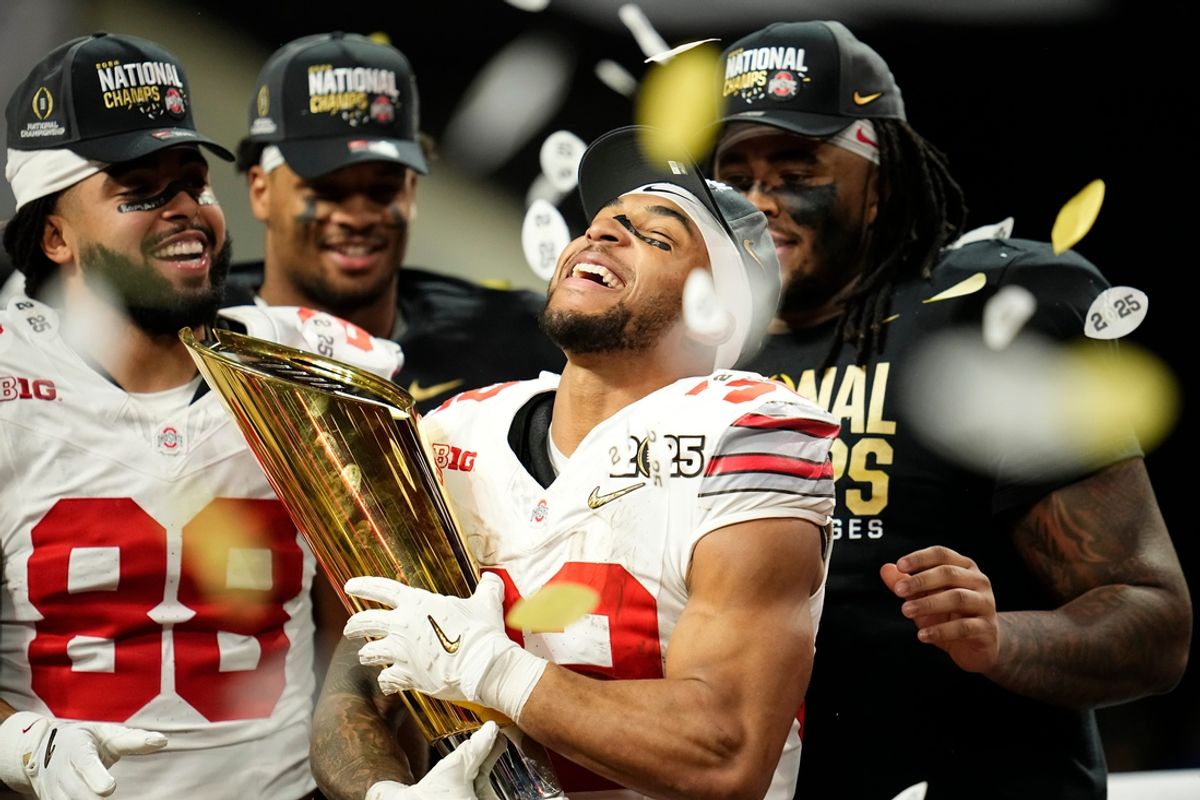 Ohio State running back TreVeyon Henderson (32) holds the national championship trophy after his team's defeat of Notre Dame in the College Football Playoff title game at Mercedes-Benz Stadium in Atlanta on Jan. 21, 2025.