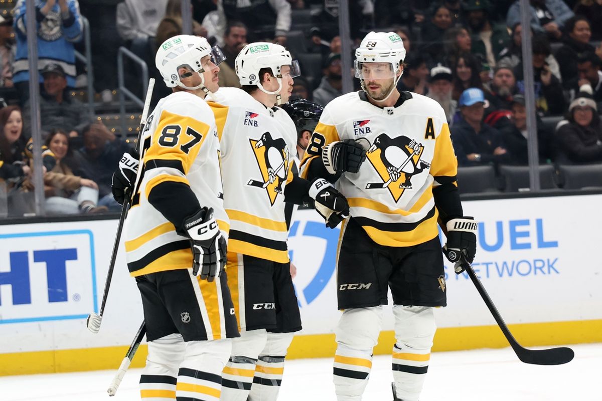 Jan 20, 2025; Los Angeles, California, USA;  Pittsburgh Penguins left wing Anthony Beauvillier (72, center) celebrates with center Sidney Crosby (87) and defenseman Kris Letang (58) after scoring a goal during the third period at Crypto.com Arena. Mandatory Credit: Kiyoshi Mio-Imagn Images