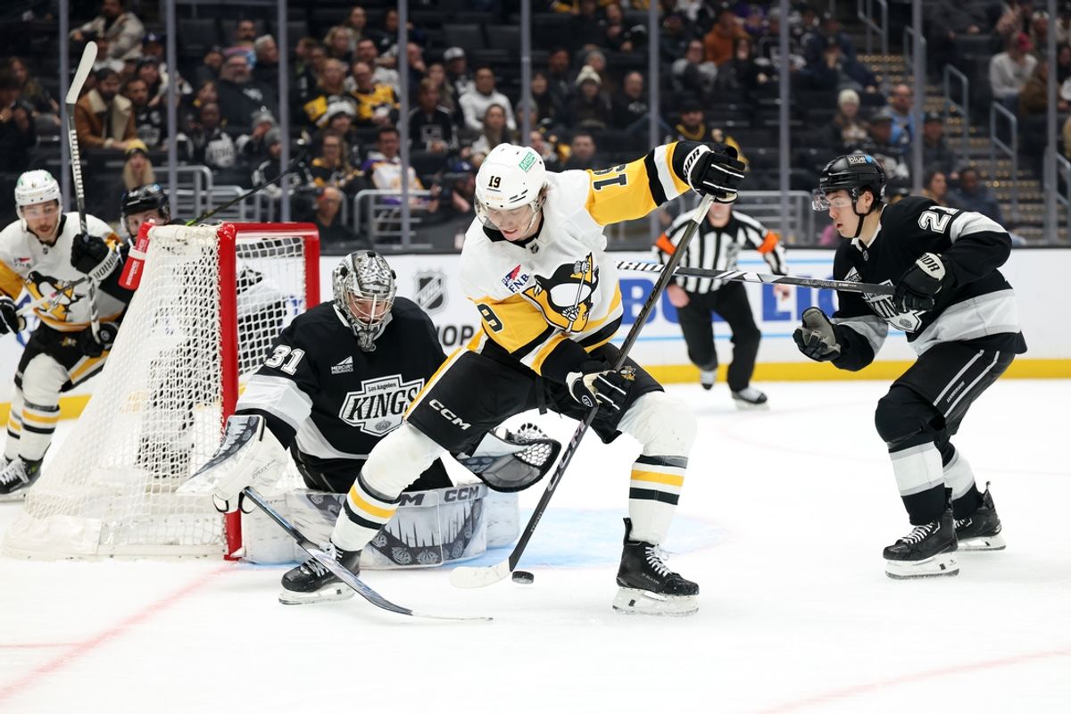 Jan 20, 2025; Los Angeles, California, USA;  Pittsburgh Penguins center Cody Glass (19) controls the puck against Los Angeles Kings goaltender David Rittich (31) during the third period at Crypto.com Arena. Mandatory Credit: Kiyoshi Mio-Imagn Images