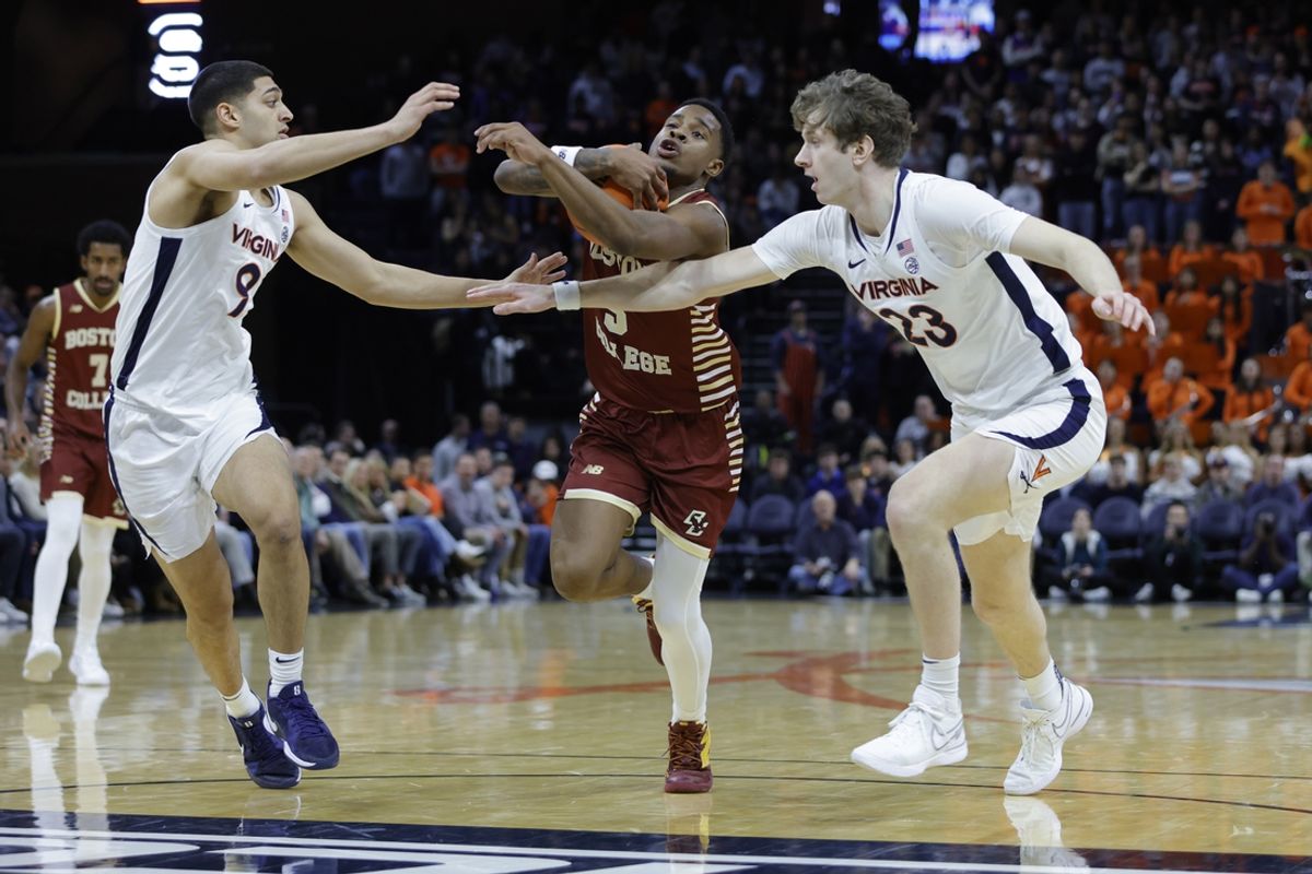 Jan 21, 2025; Charlottesville, Virginia, USA; Boston College Eagles guard Fred Payne (5) controls the ball between Virginia Cavaliers forward TJ Power (23) and Virginia Cavaliers guard Ishan Sharma (9) during the first half at John Paul Jones Arena. Mandatory Credit: Amber Searls-Imagn Images
