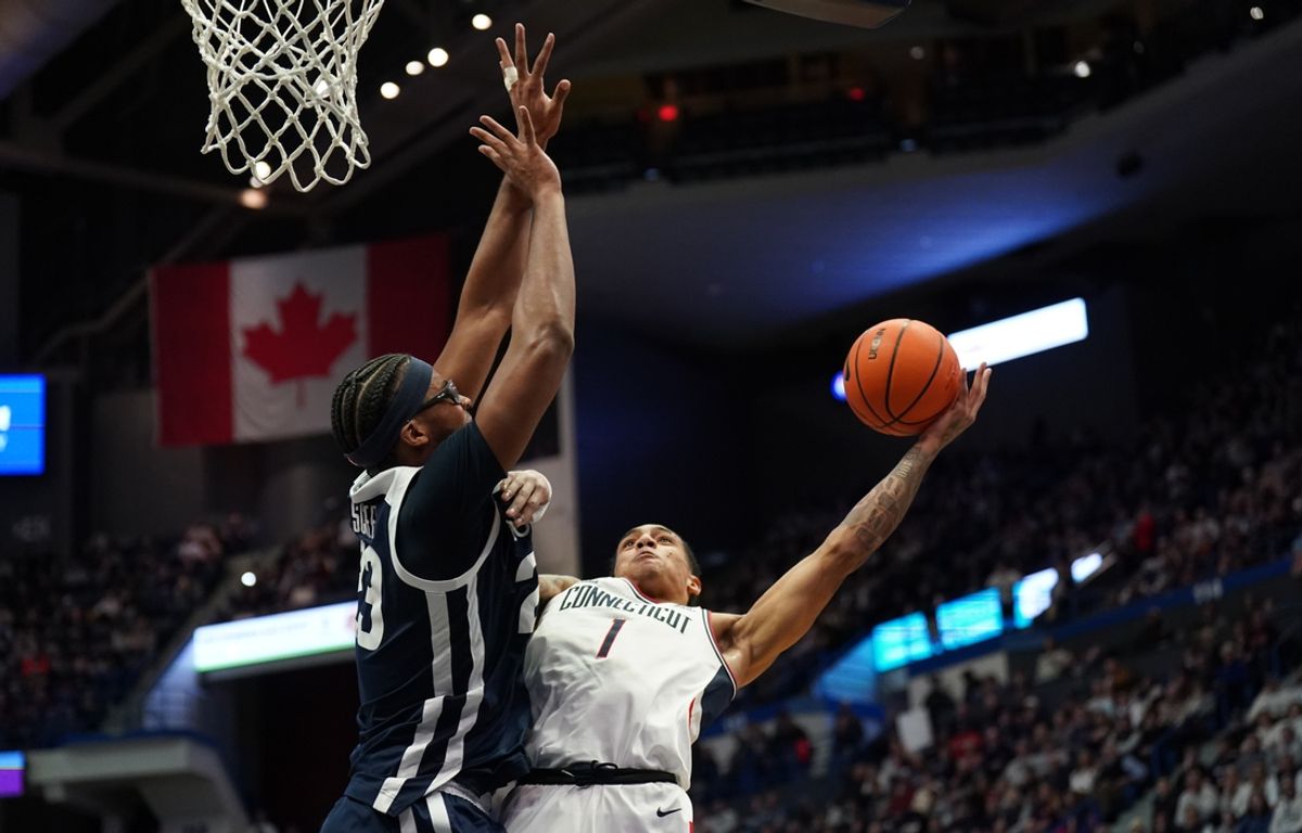 Jan 21, 2025; Storrs, Connecticut, USA; UConn Huskies guard Solo Ball (1) shoots against Butler Bulldogs center Andre Screen (23) in the first half at Harry A. Gampel Pavilion. Mandatory Credit: David Butler II-Imagn Images