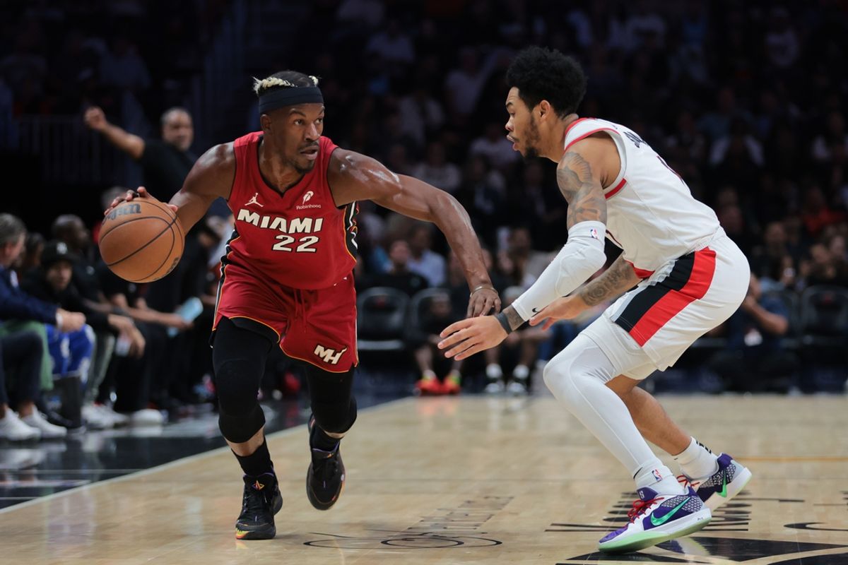 Jan 21, 2025; Miami, Florida, USA; Miami Heat forward Jimmy Butler (22) drives to the basket past Portland Trail Blazers guard Anfernee Simons (1) during the first quarter at Kaseya Center. Mandatory Credit: Sam Navarro-Imagn Images