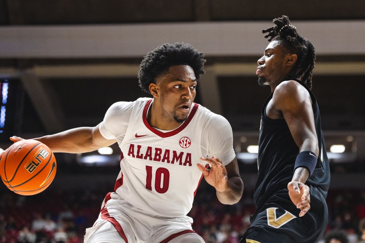 Jan 21, 2025; Tuscaloosa, Alabama, USA; Alabama Crimson Tide forward Mouhamed Dioubate (10) drives the ball against Vanderbilt Commodores guard Jason Edwards (1) during the first half at Coleman Coliseum. Mandatory Credit: Will McLelland-Imagn Images