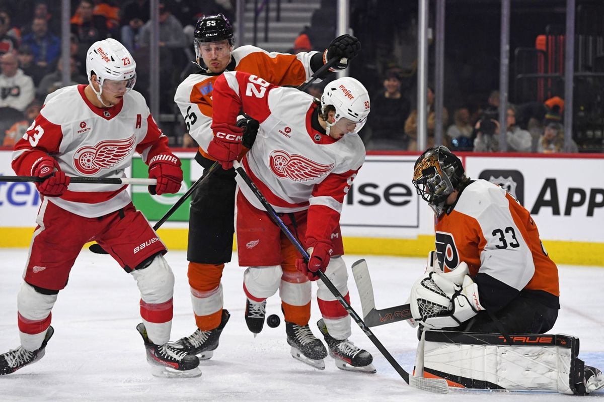 Jan 21, 2025; Philadelphia, Pennsylvania, USA; Philadelphia Flyers defenseman Rasmus Ristolainen (55) and Detroit Red Wings center Marco Kasper (92) battle the puck in front of Philadelphia Flyers goaltender Samuel Ersson (33) during the second period at Wells Fargo Center. Mandatory Credit: Eric Hartline-Imagn Images