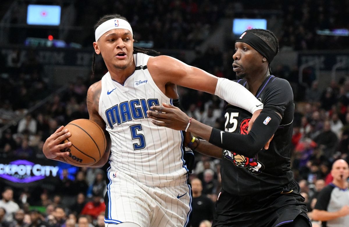 Jan 21, 2025; Toronto, Ontario, CAN;  Orlando Magic forward Paolo Banchero (5) pushes off Toronto Raptors forward Chris Boucher (25) in the first half at Scotiabank Arena. Mandatory Credit: Dan Hamilton-Imagn Images