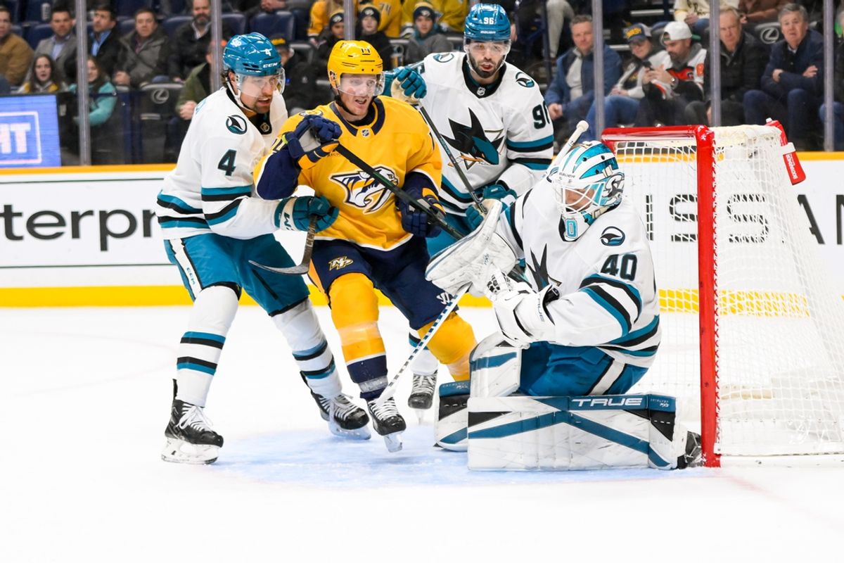 Jan 21, 2025; Nashville, Tennessee, USA;  San Jose Sharks goaltender Alexandar Georgiev (40) blocks the shot of Nashville Predators center Gustav Nyquist (14) during the first period at Bridgestone Arena. Mandatory Credit: Steve Roberts-Imagn Images