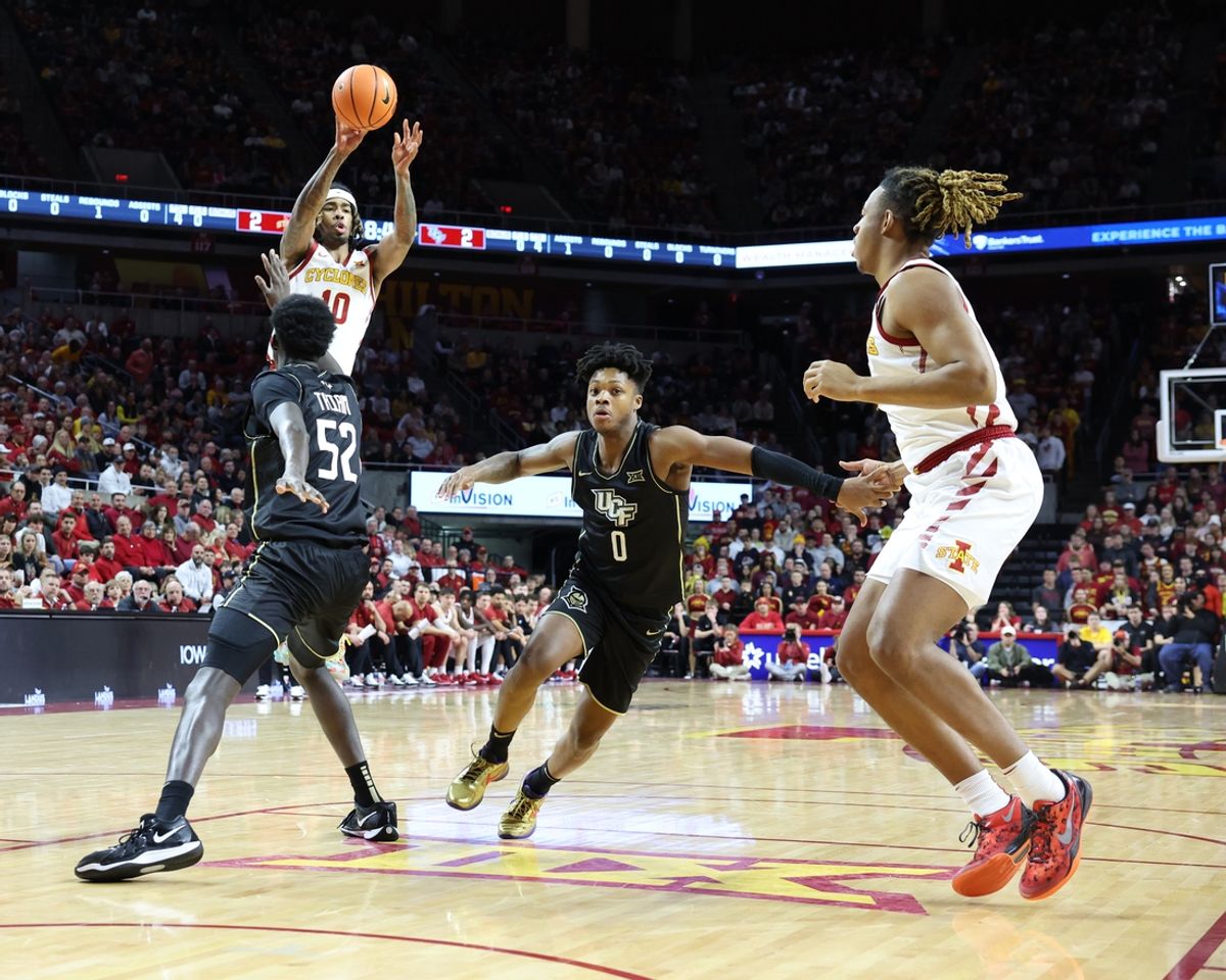 Jan 21, 2025; Ames, Iowa, USA;  Iowa State Cyclones guard Keshon Gilbert (10) passes to teammate Iowa State Cyclones center Dishon Jackson (1) over the defense of UCF Knights center Moustapha Thiam (52) and UCF Knights guard Jordan Ivy-Curry (0) during the first half at James H. Hilton Coliseum. Mandatory Credit: Reese Strickland-Imagn Images