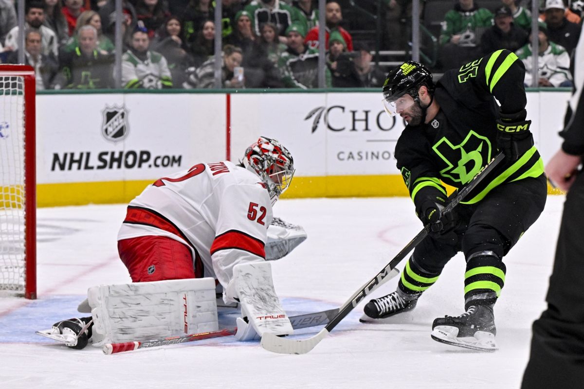 Jan 21, 2025; Dallas, Texas, USA; Carolina Hurricanes goaltender Pyotr Kochetkov (52) stops a shot by Dallas Stars center Colin Blackwell (15) during the second period at the American Airlines Center. Mandatory Credit: Jerome Miron-Imagn Images