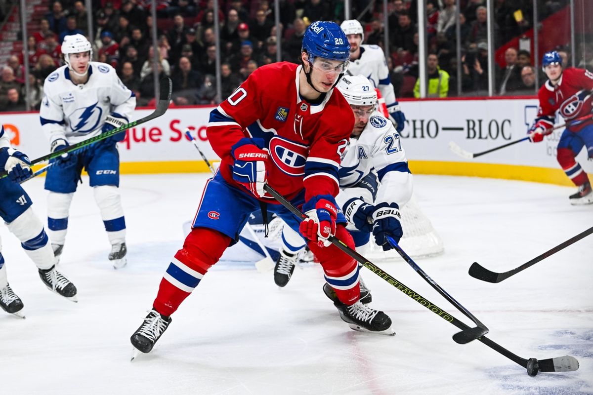 Jan 21, 2025; Montreal, Quebec, CAN; Montreal Canadiens left wing Juraj Slafkovsky (20) plays the puck against Tampa Bay Lightning defenseman Ryan McDonagh (27) during the third period at Bell Centre. Mandatory Credit: David Kirouac-Imagn Images