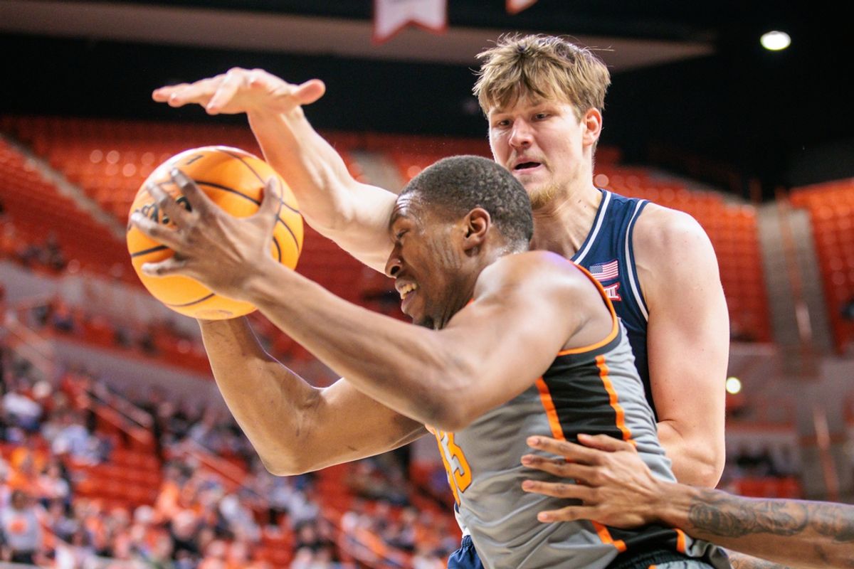 Jan 21, 2025; Stillwater, Oklahoma, USA; Oklahoma State Cowboys forward Abou Ousmane (33) drives to the basket around Arizona Wildcats forward Henri Veesaar (13) during the first half at Gallagher-Iba Arena. Mandatory Credit: William Purnell-Imagn Images