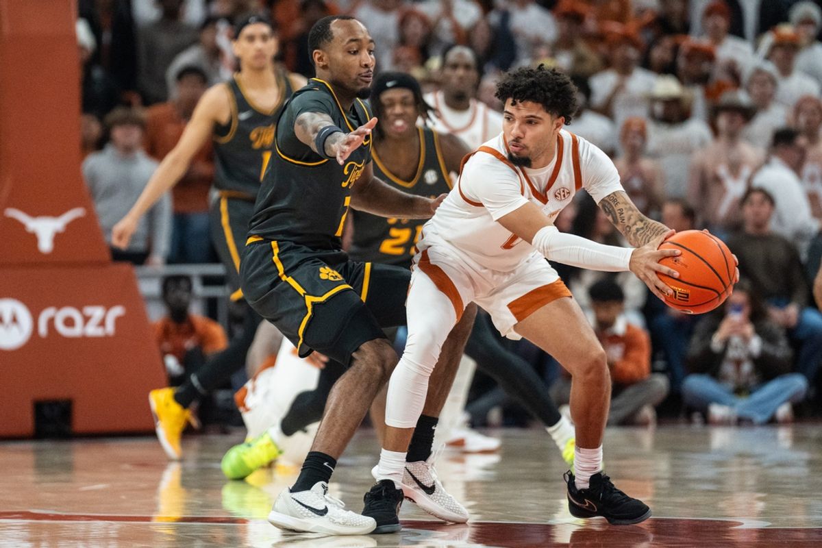 Texas Longhorns guard Jordan Pope (0) protects the ball from Missouri Tigers center Trent Burns (7) as the Longhorns take on Mizzou at the Moody Center on Jan. 21, 2025.